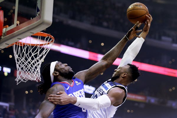 Wolves guard Josh Okogie attempted to shoot over Clippers forward Montrezl Harrell during the first half Saturday in Los Angeles.