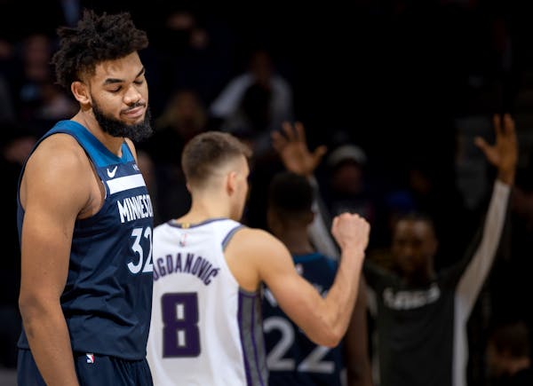 Timberwolves center Karl-Anthony Towns walked off the court in disbelief of his team's collapse as guard Bogdan Bogdanovic and the Kings celebrated th