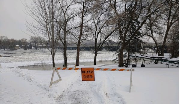 A walkway along the Mississippi River was closed Monday because of high water.