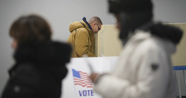 Jared Mollenkof votes at the Minneapolis Early Voting Center on Friday in Minneapolis. Mollenkof and Davis Senseman arrived the night before so they c