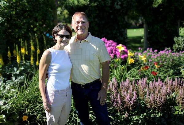 Joan and John Elton in the expansive garden that he created and tends at their home in St. Cloud.