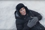 "You can take Winona out of Winona..." Ryder ponders while lying in a snowbank under the Winona, Minn. welcome sign.