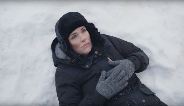 "You can take Winona out of Winona..." Ryder ponders while lying in a snowbank under the Winona, Minn. welcome sign.