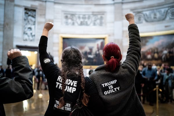 Protesters chant “acquittal is a cover-up” in the Capitol rotunda in Washington on Wednesday, Feb. 5, 2020.