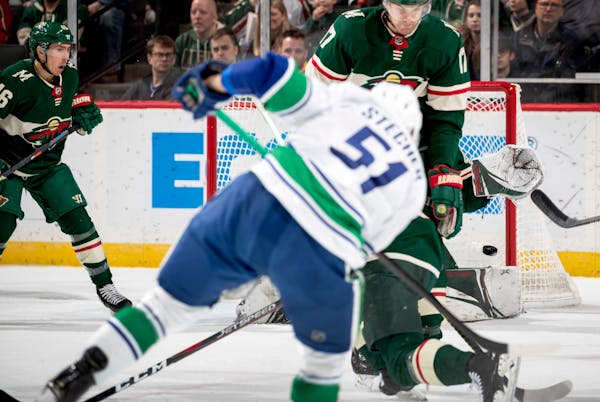 Vancouver's Troy Stecher (51) blasted the puck past Wild goalie Devan Dubnyk for a second-period goal in Minnesota's 4-1 loss at Xcel Energy Center on