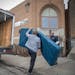 Derwin Turner, left, unloaded dozens of foam mats, along with Elim Church Lead Pastor Paul Stephen Olson, center, and KMS owner Ken McCraley, right, i