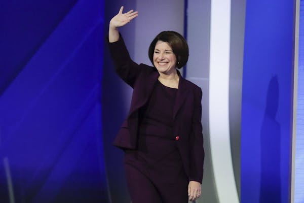 Sen. Amy Klobuchar, D-Minn., waves on stage Friday, Feb. 7, 2020, before the start of a Democratic presidential primary debate hosted by ABC News, App