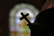 A survey by Pew Research Center found Protestants feel closer to clergy than Catholics. (AP Photo/Gerald Herbert)