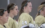 Marie Moran (15) and Mandy Moran (14) of Apple Valley stood at attention during the national anthem before a game against Simley on Jan. 21 at Eagan C