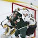 Minnesota Wild center Luke Kunin (19) tangled with Vegas Golden Knights right wing Reilly Smith (19) while camped in front of the Vegas net in the sec