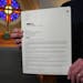 The Rev. Joel Wight Hoogheem of Lord of Life Lutheran Church in Maple Grove held a copy of one of the letters of debt forgiveness.