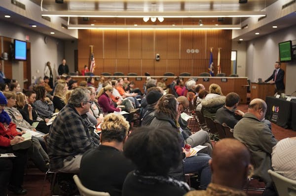 A packed room during a listening session on the Minneapolis schools' massive restructuring plan at the district headquarters on Wednesday. Families li