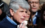 Former Illinois Gov. Rod Blagojevich dabs blood from his chin during a news conference outside his home Wednesday, Feb. 19, 2020, in Chicago.