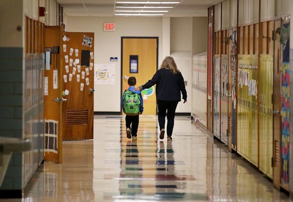 Jolie Holland, left, a nurse in the Howard Lake-Waverly-Winstead School district, comforted a student in 2019. Minnesota health officials said Sunday 