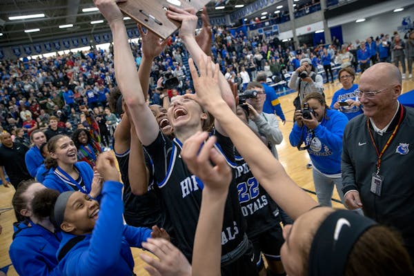 Hopkins’ Paige Bueckers held up the winning trophy after they defeated Wayzata’s 86-76 in the Class 4A, Section 6 girls' basketball championship a