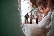 Travis Barningham, Jon Michaels and David Duffy admired a cave and ice formation nicknamed "big blue" on Wednesday.