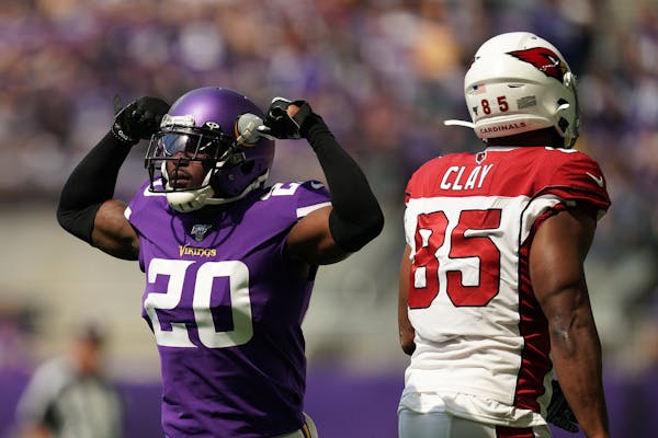 Mackensie Alexander (20) celebrated after a tackle of Cardinals tight end Charles Clay (85) during a preseason game last year at U.S. Bank Stadium.