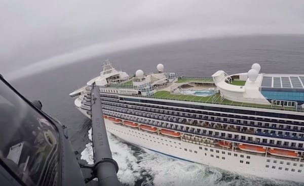 A helicopter carrying airmen with the 129th Rescue Wing flew over the Grand Princess cruise ship off the coast of California on March 5. The unidentif