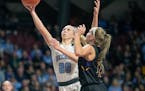 Becker’s Julia Bengtson went up for two over Waconia’s Tess Johnson during the first half of their match up in the Class 3A girls' basketball semi