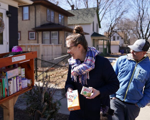 Diana Neidecker and her spouse Blake Ward, who started filling the little free library outside their home with grocery items on Monday to help those i