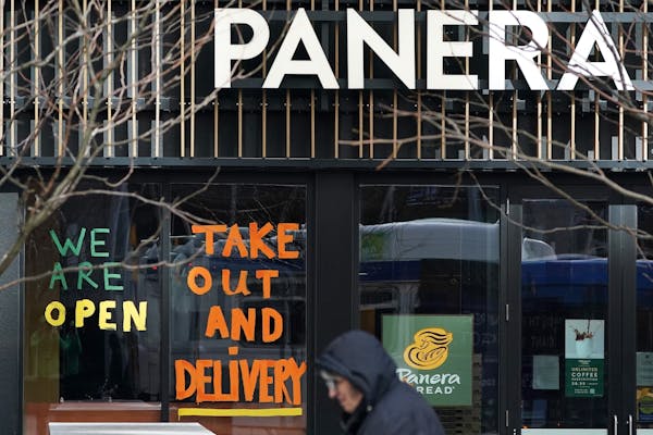 Signs alerting customers to changes in operations were painting on the windows of Panera Saturday on Nicollet Mall.