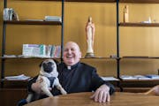 Fr. Allen Kuss and his dog Kiku-San take a break from their work at Church of St. Patrick in Edina.