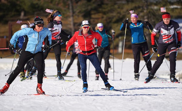 Jessie Diggins (center in red), the Olympic gold medalist from Afton, skied with local high schoolers at Theodore Wirth Park Tuesday morning. She was 