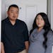 Alvin Moua and his wife, Vanishia Yang, stood outside their home, where someone left a racist, threatening note on their door linking them to the coro