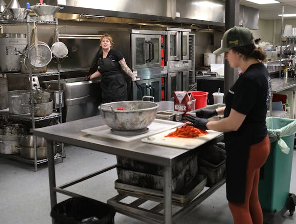 Arianna Baker-Kern, Chowgirls Killer Catering chef de cuisine, left, and Kate Kiernoziak, Chowgirls Killer Catering sous chef, prepare ingredients for