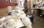 Julie Anderson, a registered nurse, cleaned and sorted though certified N95 medical masks that were donated to the Minnesota Nurses Association in Mar