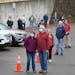 Brenda and Mike Drinken of Hudson, Wisconsin, held hands as they waited in line to vote Tuesday morning. Hudson voters were allowed into the firehouse