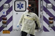 An emergency medical worker arrives at Cobble Hill Health Center, Friday, April 17, 2020, in the Brooklyn borough of New York. The despair wrought on 