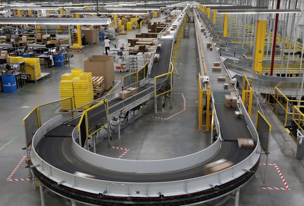 Packages passed down a conveyor bound for delivery trucks at Amazon’s Shakopee fulfillment center.