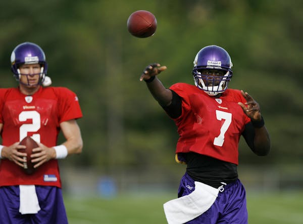 Sage Rosenfels looked on as Tarvaris Jackson threw the football during 2009 Vikings training camp in Mankato. Both were competing for the starting job