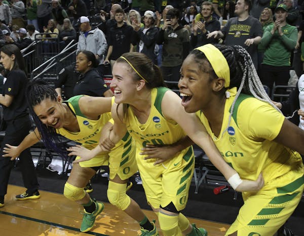 Oregon standouts Sabrina Ionescu, center, and Satou Sabally, left, figure to be two of the top three picks in the upcoming WNBA draft. Might Ruthy Heb