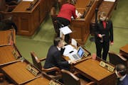 House Speaker Melissa Hortman, standing right, conferred with Majority Leader Ryan Winkler on the House floor last week.