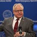 Minnesota Gov. Tim Walz answered questions about extending his stay-at-home order while holding a face mask Thursday in St. Paul.