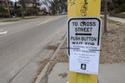 The city of Minneapolis has retired the “beg buttons” in hundreds of intersections, to protect public health. This sign appeared at 48th Street an
