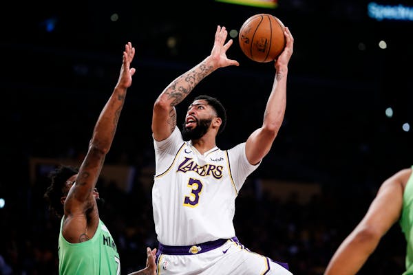 The Lakers’ Anthony Davis shot over the Timberwolves’ Jordan Bell on Sunday night in Los Angeles. Davis scored 50 points on 20-for-29 shooting and