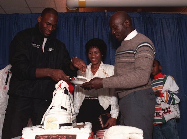 Michael Jordan serves his father, James, right, a slice of birthday cake while his mother, Deloris watches during a party in honor of Jordan's 26th bi