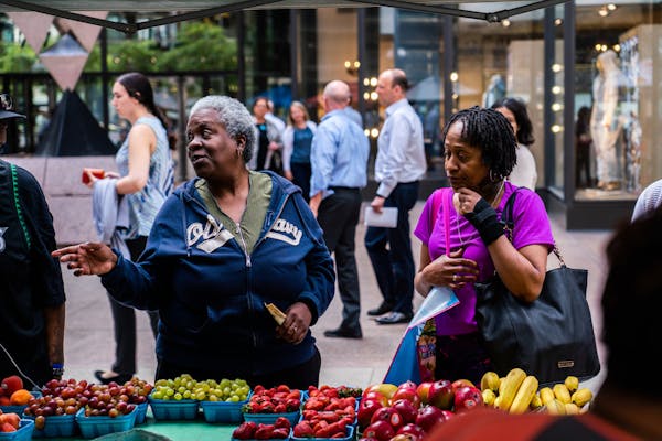 Ann Walker and LaTanya Becton browsed fruits at the Patnode Produce stall on Nicollet Mall in downtown Minneapolis in May 2018.