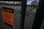 The tennis courts at Lyndale Farmstead Park in Minneapolis were locked up and closed due to the COVID-19 pandemic.