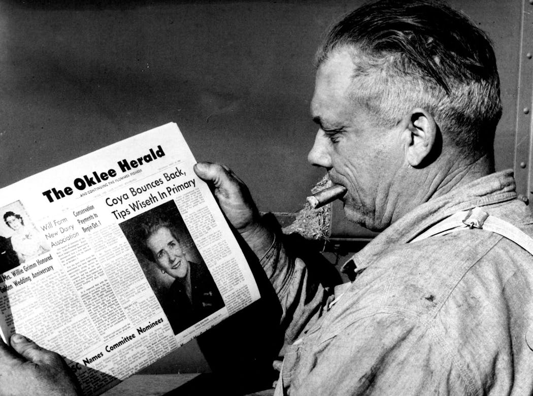 Andy Knutson is pictured in 1960 reading his hometown newspaper featured a story about his wife, former Congresswoman Coya Knutson's comeback bid, something he said he supported.