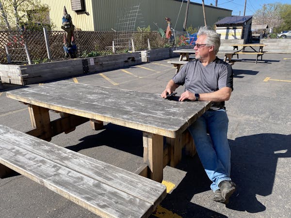 Tom Hanson sat at one of a few tables that he had put in the parking lot of his popular Duluth Grill.