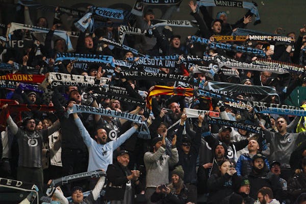 Minnesota United fans celebrate at the end of an MLS soccer match in Portland