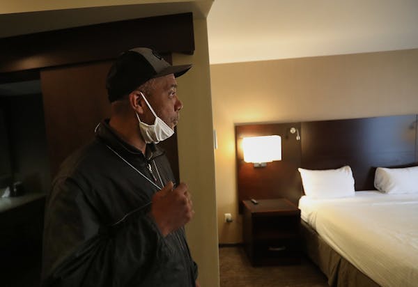 After moving out of the Higher Ground homeless shelter in Minneapolis, Douglas Pyle, 49, reacts to seeing his hotel room for the first time Friday.