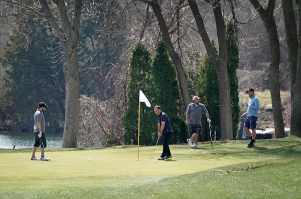 Golfers at Stonebrooke Golf Club in Shakopee enjoyed Friday’s spring weather but took care to practice social distancing.