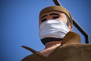 Pierre the Voyageur statue in Two Harbors, MN has been fitted with a mask amidst the COVID-19 pandemic and stood tall on April 23, 2020.