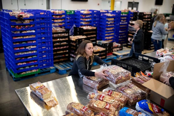 Kimberly Lawrence of Rosemount, a volunteer, packs loaves of bread at Second Harvest. Staff and volunteers at Second Harvest Heartland, the state’s 