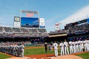In this April 5, 2018, file photo, a flyover of four Air Force jets comes over Target Field after the national anthem as the Mariners and the Twins li